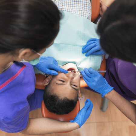 Dentists working in dental clinic Dentists during a dental intervention with a patient. Dentist Concept
